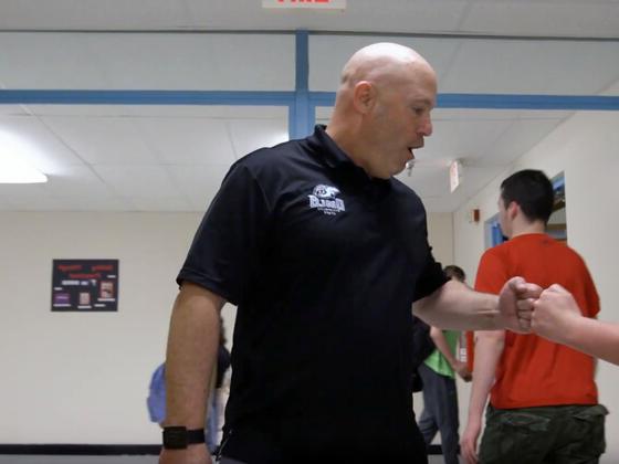 Westminster High School principal fist bumps with students