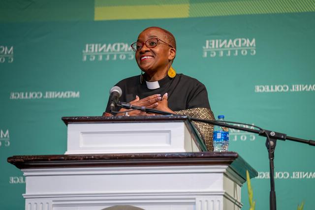Rev. Nontombi Naomi Tutu speaking at a podium at McDaniel's Black History Month Convocation.